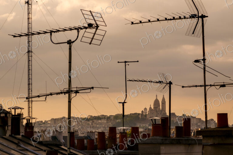 Sacré-Cur Basilica viewed through television aerial antennae and apartment rooftops.
